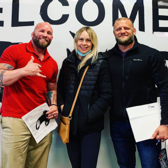 Closing-day photo in front of a Welcome wall